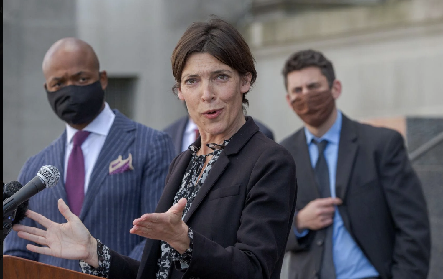 The chief of the DA's civil rights division, Emily Maw, talks with the media