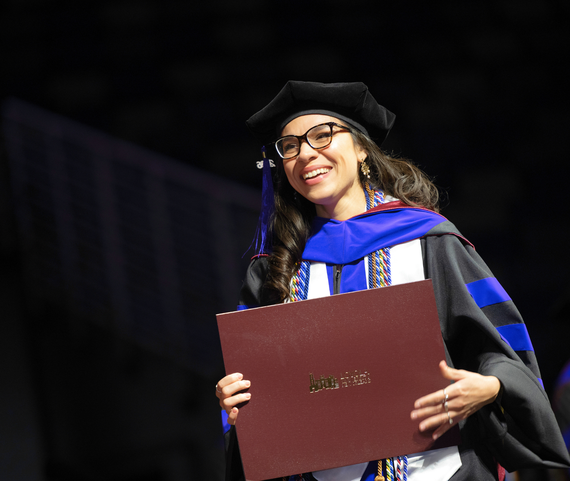A student receiving her diploma at law graduation.
