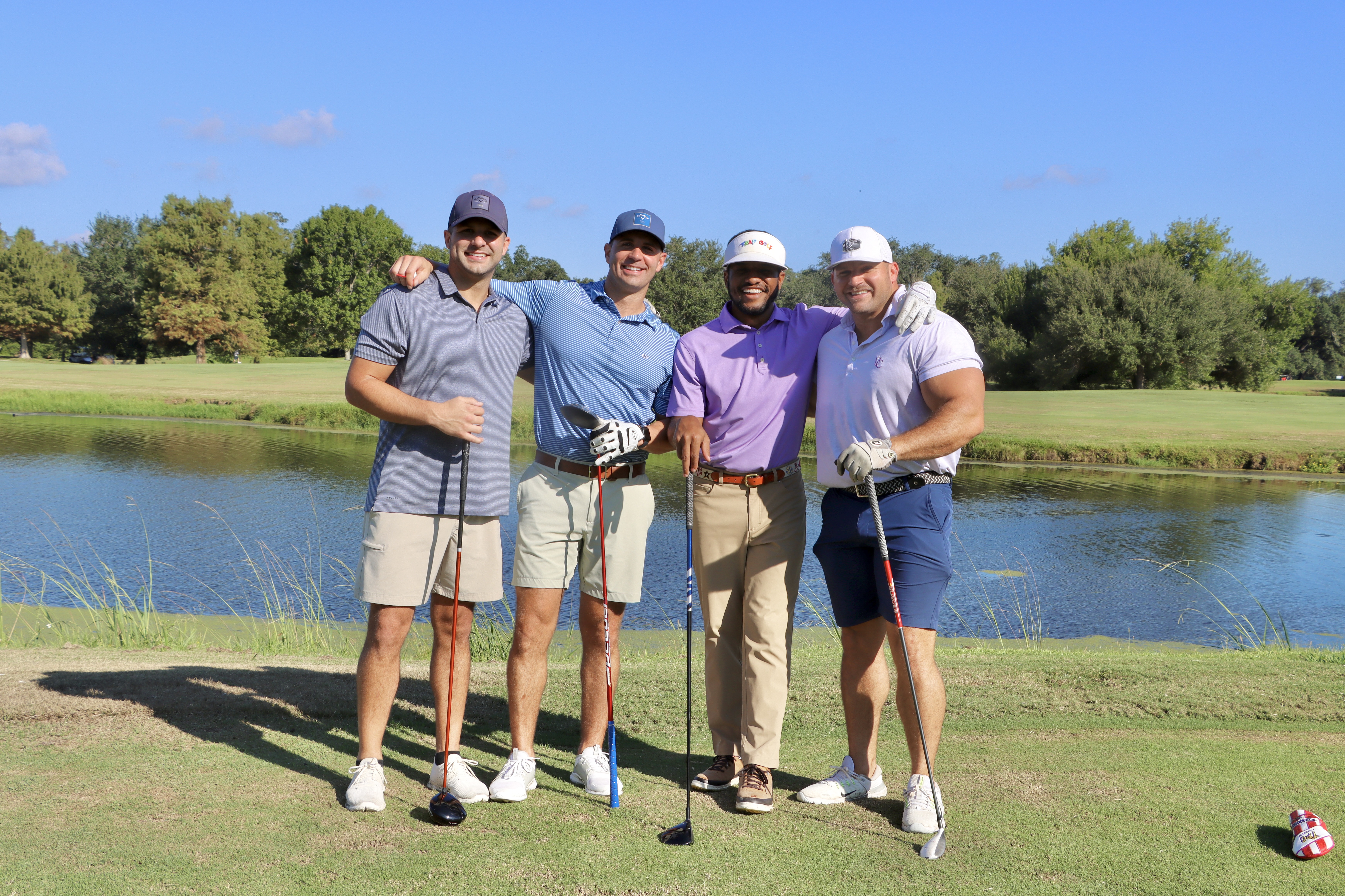 four men playing golf